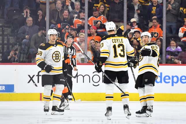 Apr 9, 2023; Philadelphia, Pennsylvania, USA; Boston Bruins center Charlie Coyle (13) celebrates his goal with defenseman Connor Carrick (58) and left wing Brad Marchand (63) against the Philadelphia Flyers during the first period at Wells Fargo Center.