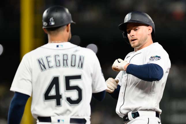 Sep 11, 2023; Seattle, Washington, USA; Seattle Mariners right fielder Jarred Kelenic (10) celebrates with first base coach Kristopher Negr  n (45) after hitting a single against the Los Angeles Angels during the fifth inning at T-Mobile Park.
