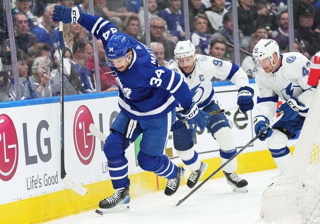 Apr 20, 2023; Toronto, Ontario, CAN; Toronto Maple Leafs center Auston Matthews (34) battles for the puck with Tampa Bay Lightning center Steven Stamkos (91) during the first period in game two of the first round of the 2023 Stanley Cup Playoffs at Scotiabank Arena.