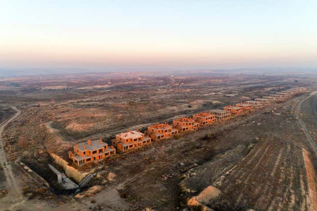 An aerial view of a partially built housing development.