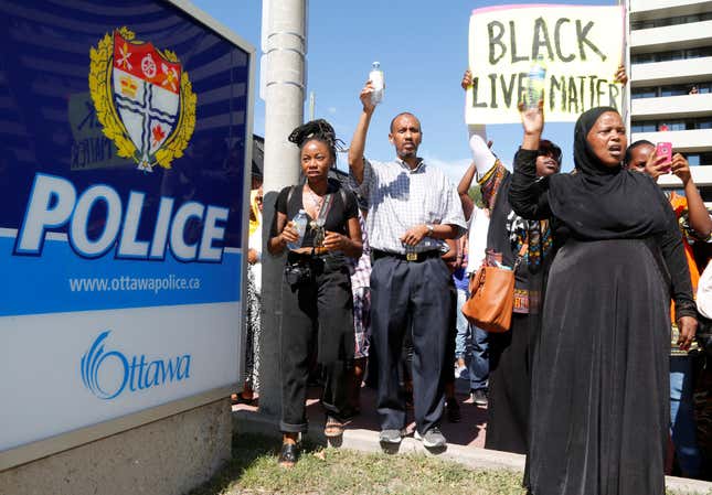 Protesters shout as they arrive at a police station during a protest march in Ottawa, Canada, on July 30, for Abdirahman Abdi.