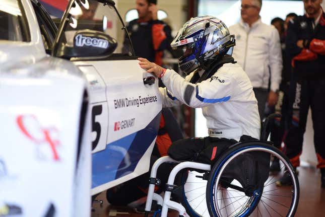 Alex Zanardi opens the door of a BMW race car
