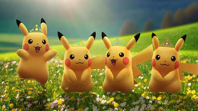 Pikachu wearing crowns in a green field.