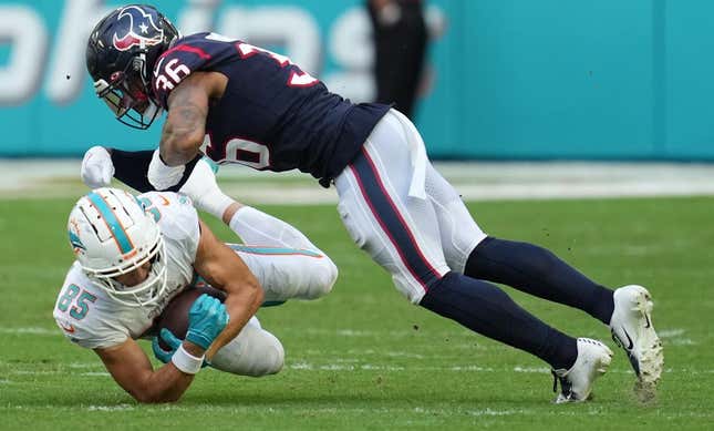 Miami Dolphins wide receiver River Cracraft (85) hauls in a catch as Houston Texans safety Jonathan Owens (36) closes in for the tackle during the first half of an NFL game at Hard Rock Stadium in Miami Gardens, Nov. 27, 2022.