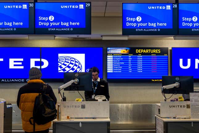 A traveler waits at a United Airlines counter at the Austin-Bergstrom International Airport on January 31, 2023 in Austin, Texas. Many flights have been delayed and cancelled due to a winter storm passing through portions of Texas.