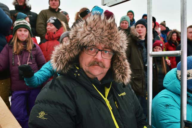 Spectators wait to hear the winner of the race.