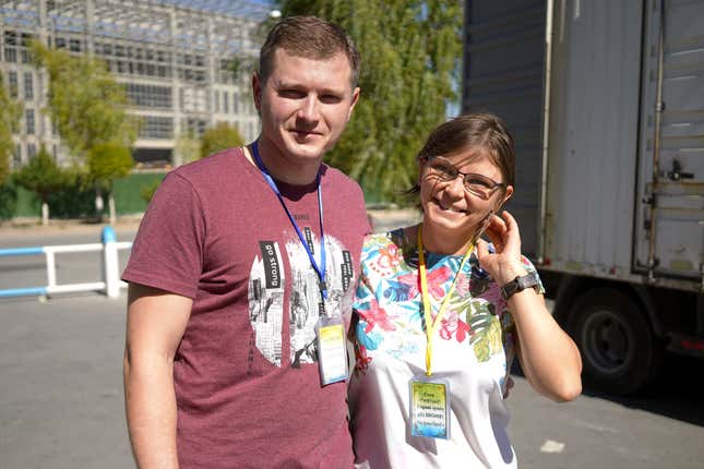 Anna Shalygin and Alexander Shalygin, stand in front of a complex in construction on the Chinese side of Khorgos ICBC.