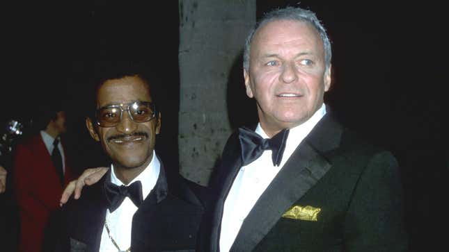 Rat Pack members Frank Sinatra and Sammy Davis, Jr. walk the red carpet at an event in circa 1970. 
