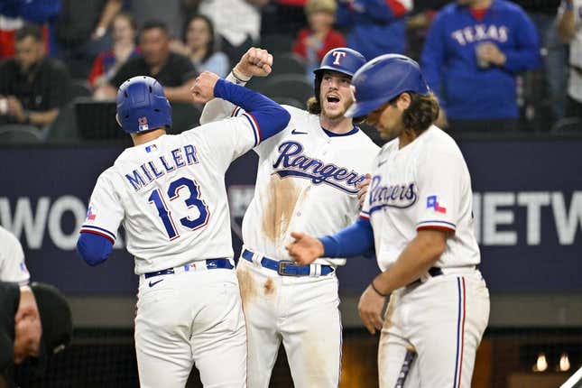 Mar 30, 2023; Arlington, Texas, USA; Texas Rangers designated hitter Brad Miller (13) and catcher Jonah Heim (28) celebrate after Miller hits a two run home run against the Philadelphia Phillies during the fifth inning at Globe Life Field.