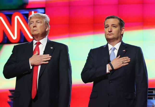 Republican presidential candidates Donald Trump and Sen. Ted Cruz (R-TX), listen to the national anthem before the start of the CNN, Salem Media Group, The Washington Times Republican Presidential Primary Debate on the campus of the University of Miami on March 10, 2016 in Coral Gables, Florida. 