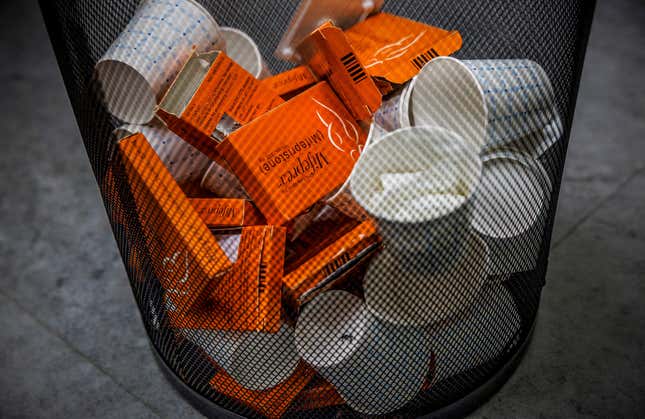 Used boxes of Mifepristone pills in a trash can
