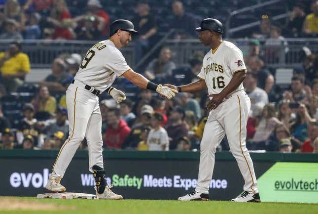 Jun 28, 2023; Pittsburgh, Pennsylvania, USA;  Pittsburgh Pirates third baseman Jared Triolo (19) celebrates his first major league hit with first base coach Tarrik Brock (16) against the San Diego Padres during the eighth inning at PNC Park. Pittsburgh won 7-1.