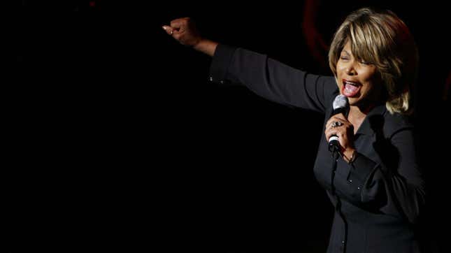 Tina Turner onstage, singing into a microphone