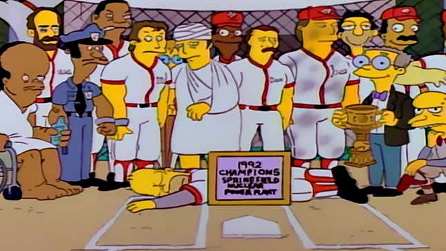 A screenshot of The Simpsons shows Homer passed out in front of baseball players. 