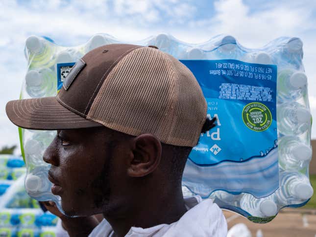 Residents distribute cases of water at Grove Park Community Center in Jackson, Mississippi, on September 3, 2022