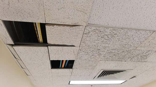 broken acoustic tiles in a drop ceiling