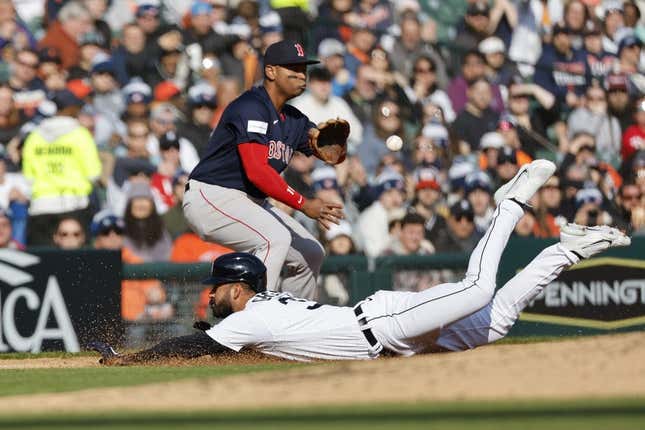 Apr 8, 2023; Detroit, Michigan, USA;  Detroit Tigers center fielder Riley Greene (31) dives in safe at third ahead of the throw to third baseman Rafael Devers (11) in the fourth inning at Comerica Park.