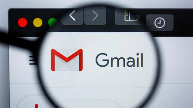 A magnifying glass over the Gmail logo on a computer is shown.