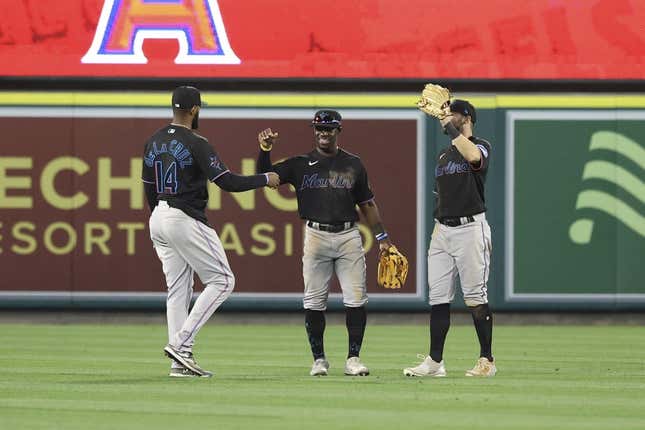 May 27, 2023; Anaheim, California, USA; Miami Marlins left fielder Bryan De La Cruz (14) and Miami Marlins center fielder Jonathan Davis (49) embrace after defeating the Los Angeles Angels 8-5 at Angel Stadium.