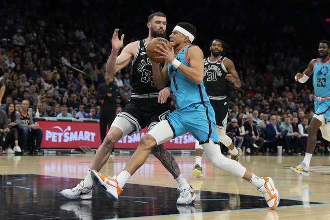 Apr 4, 2023; Phoenix, Arizona, USA; Phoenix Suns guard Devin Booker (1) drives on San Antonio Spurs forward Sandro Mamukelashvili (54) in the first half at Footprint Center.