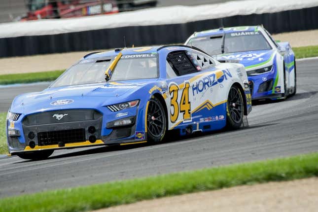 NASCAR Cup Series driver Michael McDowell (34) leads NASCAR Cup Series driver Chase Elliott (9) around the track Sunday, Aug. 13, 2023, before winning the Verizon 200 at the Brickyard at Indianapolis Motor Speedway.