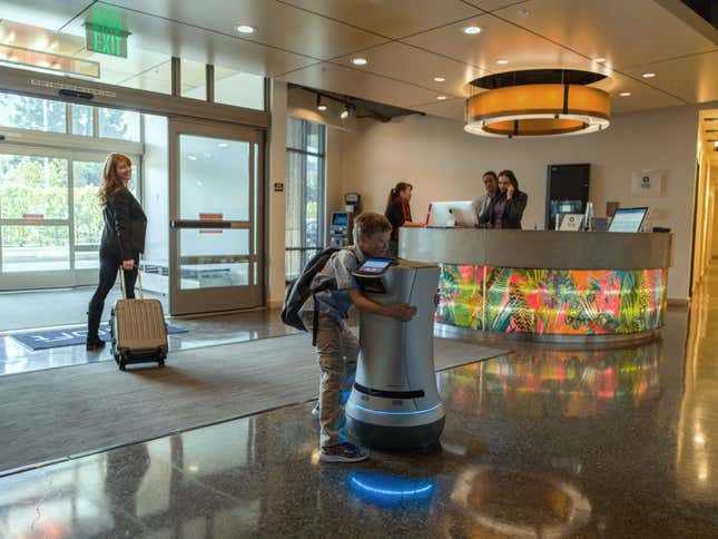 A Relay robot in a hotel, with an affectionate child for scale.