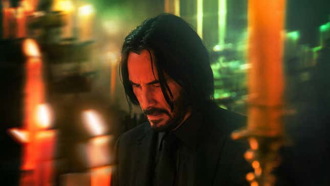 John Wick bows his head in sadness and resignation.