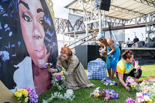 LOUISVILLE, KY - JUNE 05: Protesters and volunteers prepare a Breonna Taylor art installation by laying posters and flowers before the “Praise in the Park” event at the Big Four Lawn on June 5, 2021 in Louisville, Kentucky. 