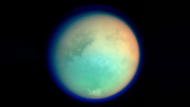 A pale blue image of Saturn's largest moon, Titan.