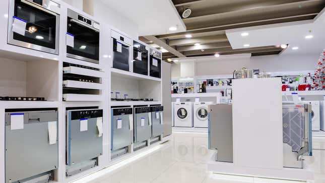 inside of appliance store with stoves, microwaves and washing machines on display