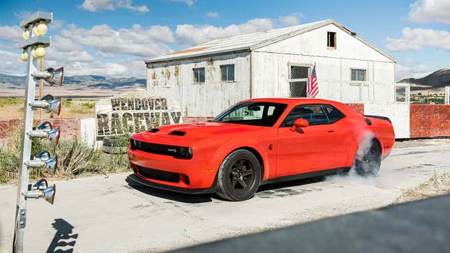 A photo of an orange Dodge Challenger muscle car. 