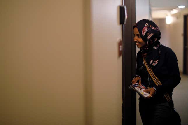 U.S. Democratic congressional candidate Ilhan Omar "door knocks" to encourage voters to cast ballots in the midterm elections in Minneapolis, Minnesota, U.S., October 26, 2018. Picture taken October 26, 2018.