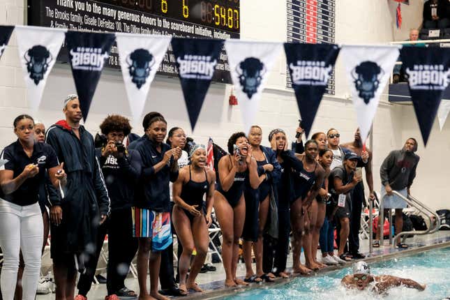 Members of the Howard University swim team cheer as Howard University competes with Georgetown University at the Howard University Swimming Battle at the Burr, on October 1, 2022 in Washington, D.C
