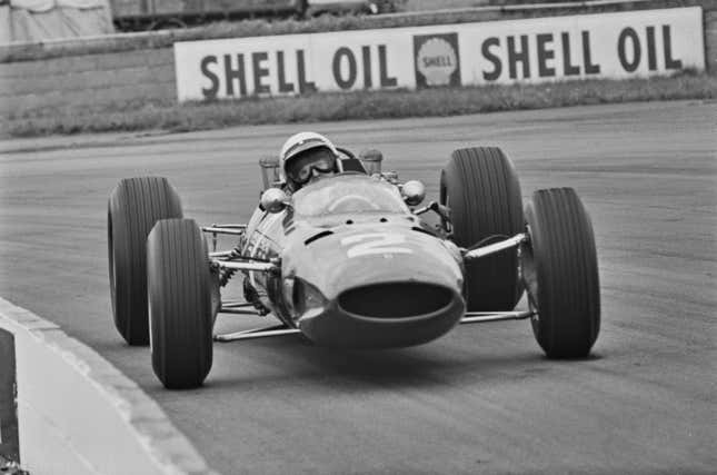 Italian racing driver Lorenzo Bandini (1935 - 1967) driving a Ferrari in the 1965 British Grand Prix.