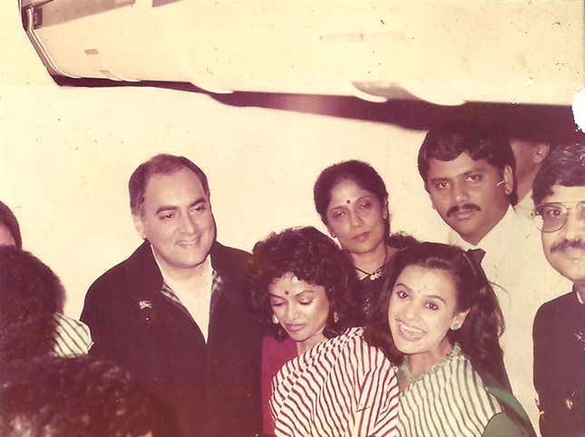 Elfin Fernand (in red sari) with Rajiv Gandhi after the former prime minister took a VIP flight on Air India.