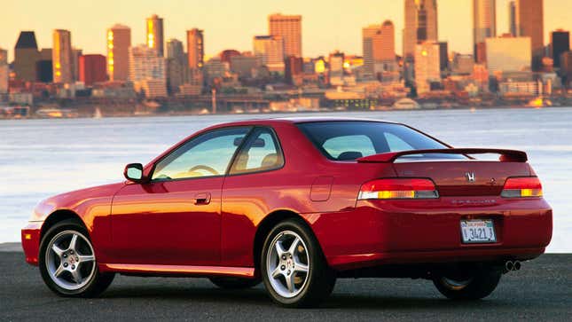 A photo of a red Honda Prelude at sunset. 