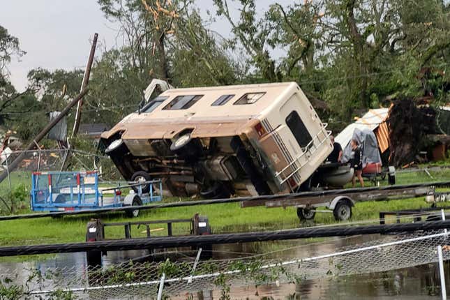 A mobile home is turned on its side off Main Street in Moss Point, Mississippi after a tornado struck the town, on June 19, 2023.