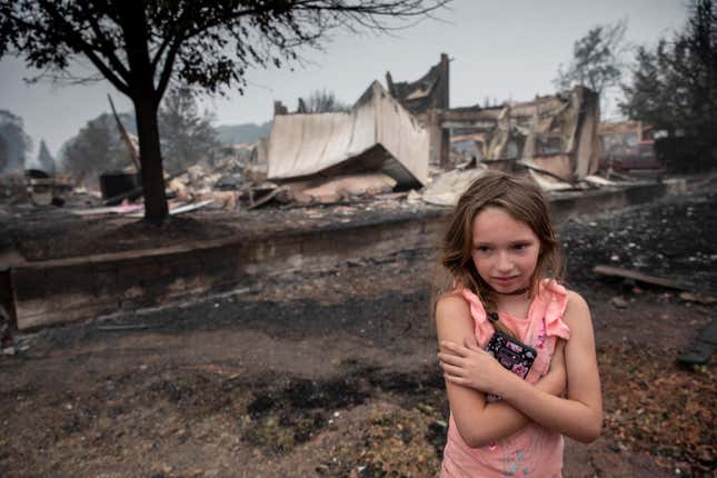 Girl in front of burned building