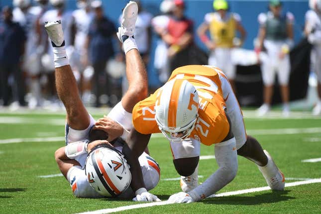 Sep 2, 2023; Nashville, Tennessee, USA; Virginia Cavaliers quarterback Tony Muskett (11) is sacked by Tennessee Volunteers defensive lineman James Pearce Jr. (27) during the first half at Nissan Stadium.