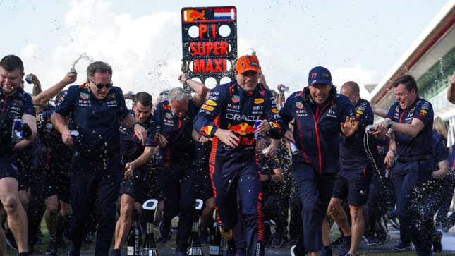 Red Bull Racing Team Principal Christian Horner, Max Verstappen, and Sergio Perez (left-right) covered in champagne following the British Grand Prix 2023 at Silverstone, Towcester.