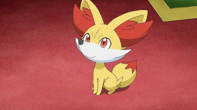 Fennekin is seen sitting on a red carpet and looking up at something.