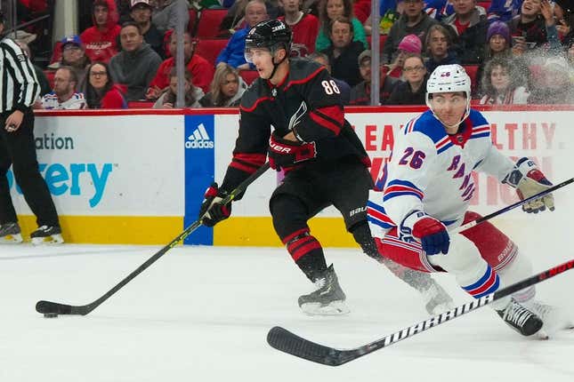 Feb 11, 2023; Raleigh, North Carolina, USA;  Carolina Hurricanes center Martin Necas (88) and New York Rangers left wing Jimmy Vesey (26) during the first period at PNC Arena.