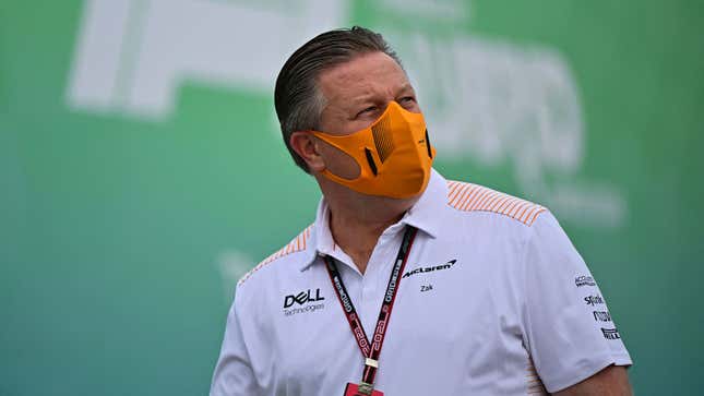 McLaren CEO Zak Brown wearing an orange face mask. 