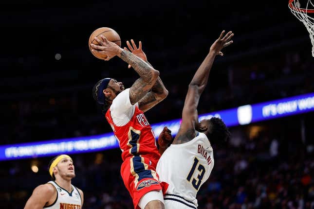 Mar 30, 2023; Denver, Colorado, USA; New Orleans Pelicans forward Brandon Ingram (14) drives to the net against Denver Nuggets center Thomas Bryant (13) in the first quarter at Ball Arena.