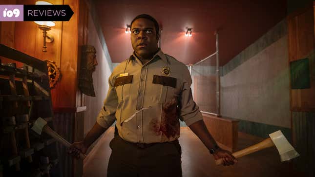 A park ranger (Sam Richardson) holds a pair of axes as he faces down a threat in Werewolves Within.