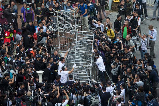 Building employees dismantle a barricade outside Citic Tower in accordance with a court injunction to clear up part of the protest site.