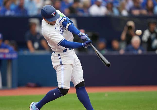 Sep 9, 2023; Toronto, Ontario, CAN; Toronto Blue Jays right fielder George Springer (4) hits a home run against the Kansas City Royals during the seventh inning at Rogers Centre.