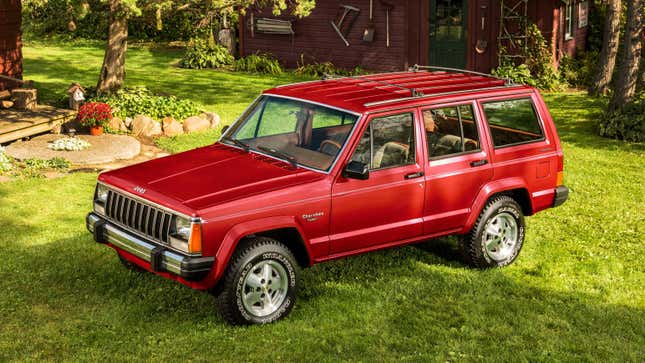 Stellantis press image of a red XJ Cherokee, viewed from the front quarter and slightly above.
