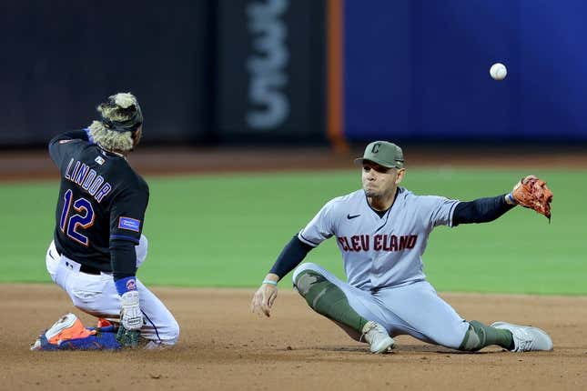May 19, 2023; New York City, New York, USA; New York Mets shortstop Francisco Lindor (12) slides safely into second base for a double as the throw from the outfield gets away from Cleveland Guardians second baseman Andres Gimenez (0) during the fifth inning at Citi Field.