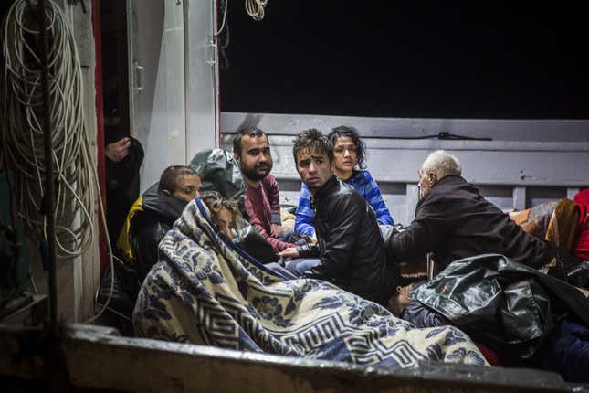 Refugees arriving at the port of Molivos on a fishing boat after their own boat sank in the Aegean. They were among 242 people rescued.